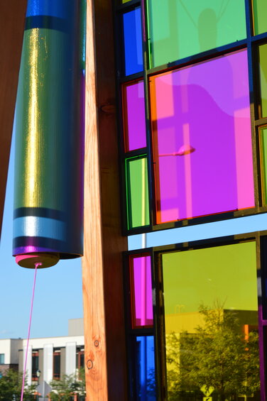 Colorful light reflects from the new outdoor art installation in front of the Lone Tree Arts Center on Aug. 30, 2023.